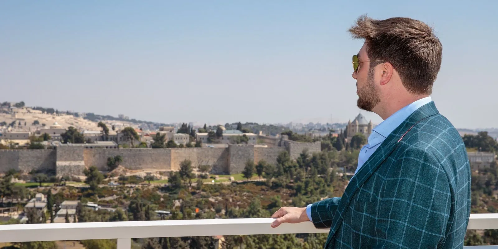 Daniel Seal looking out over an old city from a terrace