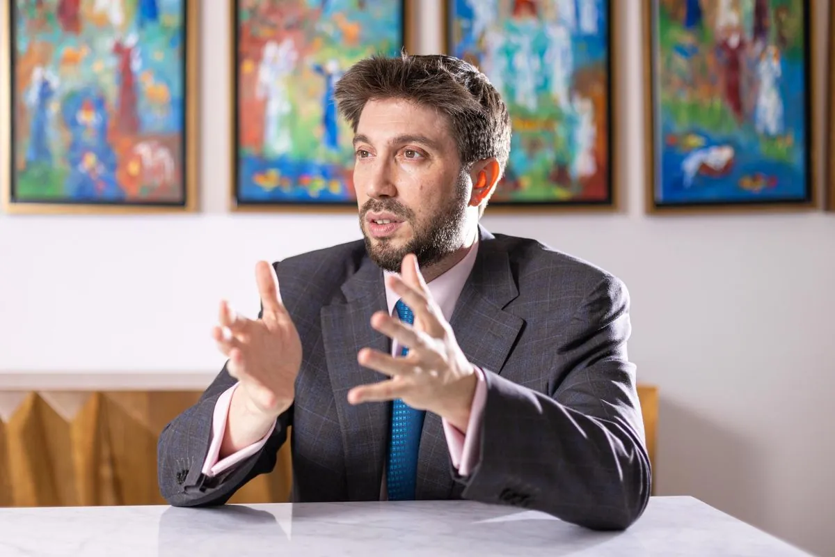 Daniel Seal speaking at a meeting table